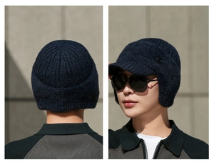 Detailed views of a navy blue winter knit hat with ear flaps and short brim for men