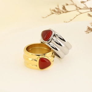 Macro detail of irregular gold and silver rings with inlaid triangular red turquoise stones