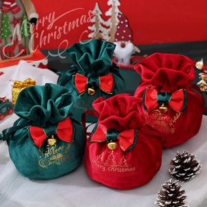 Velvet Christmas drawstring gift bags with gold stamping and festive bows in red and green