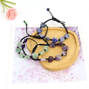 Detailed view of hand-woven yoga bracelets with heart-shaped natural crystals and adjustable cord