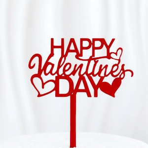 Detail of red acrylic Happy Valentine's Day cake topper with heart design for baking decoration