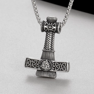 Macro view of Viking Thor's Hammer pendant with intricate Celtic knot and Valknut symbols