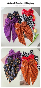Detail of Halloween hair clips featuring satin bows with spider web and pumpkin prints