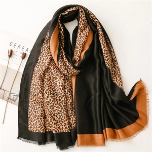 Elegant leopard print scarf with color-block borders and delicate fringe edges