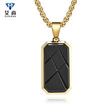 Macro view of gold box chain and black rectangular geometric pendant with subtle reflection