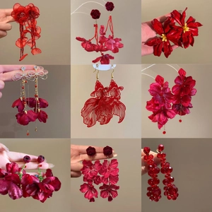 Collection of red Chinese style earrings featuring koi fish and floral fabric petal designs