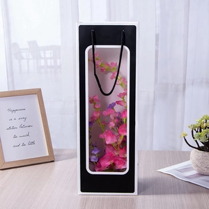 Elegant black wine gift bag with clear window and handles for wedding and party favors