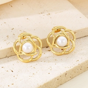 Detailed macro view of 18K gold plated flower earring with central pearl inlay