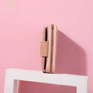 Side view of pink leather zip wallet showing multiple layers and gold metal zipper