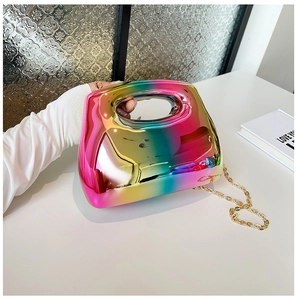 Macro shot of rainbow gradient mirror finish handbag with elegant gold chain strap