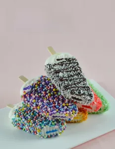 Macro shot of assorted PU fake ice cream bars with colorful toppings and wooden sticks