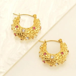 Detailed view of 18K gold plated hoop earrings with pink zircons and woven texture