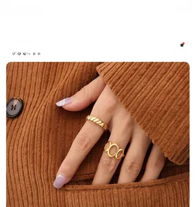Detail of 18K gold plated geometric ring set featuring spiral and hollow band designs