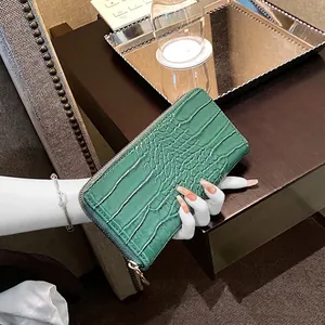 Elegant green crocodile pattern wallet with gold zipper and long textured design
