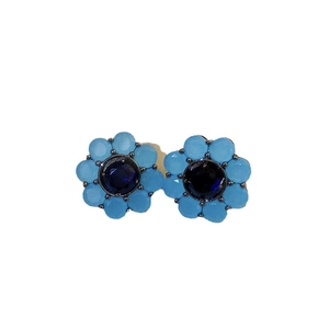 Elegant vintage light blue flower stud earrings with a deep blue faceted gemstone center