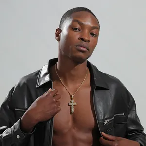 Close-up of a gold cross pendant with micro-pave zircons on a male model with rope chain