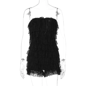 Detail view of black lace tube top featuring tiered layers and delicate ribbon bow detail