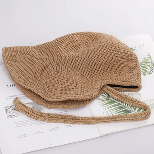 Detail showing high-quality straw weave texture and chin strap on a sun hat