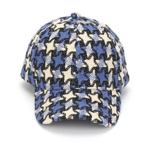 Detailed close-up of thick blue and black plaid tweed texture on a baseball cap