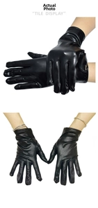 Detalle de guantes punk de charol negro brillante mostrando el ajuste y el acabado