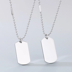 Close-up of dual silver rectangular military dog tags on bead chains with metallic finish