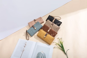Close-up of vintage frosted long wallets in multiple colors with leaf pattern buckle