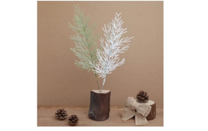 Detail of green and white artificial pine branches in wooden vase for Christmas DIY decor