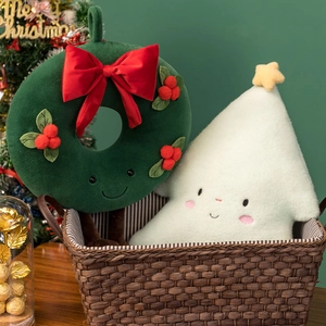 Close-up of plush Christmas wreath and white tree dolls with cute faces in a basket