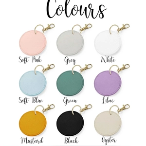 Custom round faux leather keychains in nine colors with gold metallic rings and hooks