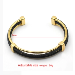 Detail shot of black and gold braided steel wire open bracelet with size and weight info