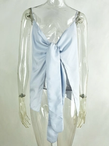 Detail showing the light blue satin camisole top with a large decorative front bow