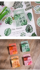 Close-up of botanical forest themed stickers in portable boxes for journaling decor