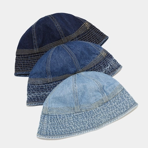 Detail view of denim bucket hats in dark blue, medium blue and light blue wash