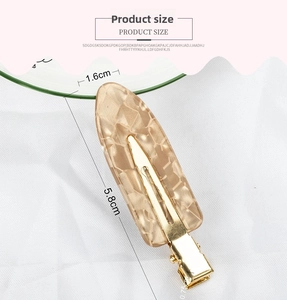 Detail view of champagne alligator hair clip with diamond texture, size 5.8cm by 1.6cm