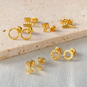Hammered gold geometric stud earrings set in various shapes including circles and bars