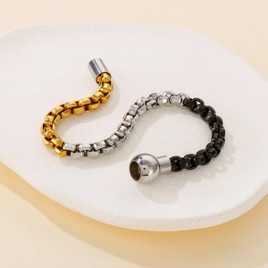 Three-tone stainless steel box chain bracelet in gold, silver, and black with magnetic clasp
