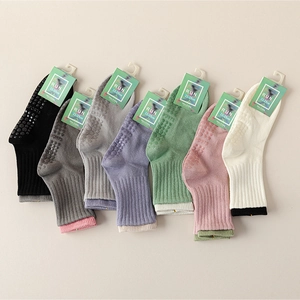 Multi-color anti-slip cotton yoga socks with silicone grips shown in diagonal stack