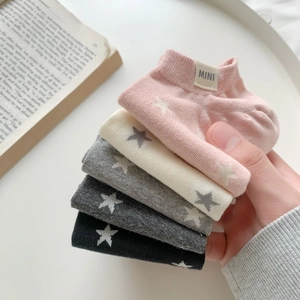 Detail of five-pair set of cotton baby ankle socks featuring knit star patterns