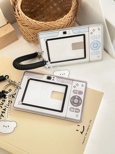 Detailed view of retro camera acrylic card holders with white bear charms and lanyards