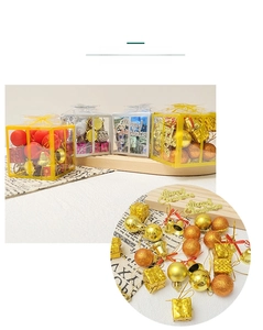 Close-up of Christmas tree ornaments including shiny baubles, tiny bells, and gift boxes