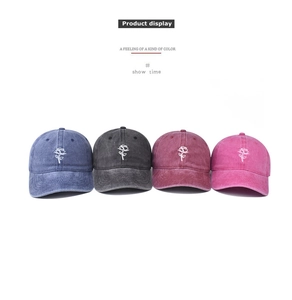 Detail showing vintage washed cotton baseball caps with elegant white rose embroidery