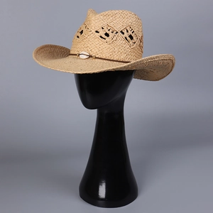 Western straw cowboy hat with hollow weave pattern and shell pendant on black head form