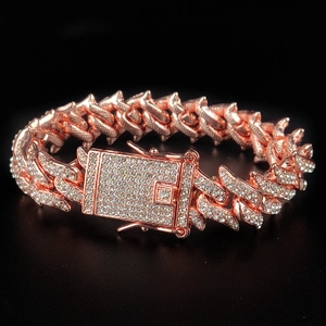 Detail of rose gold iced out Cuban link chain with sparkling pavé crystals and box clasp