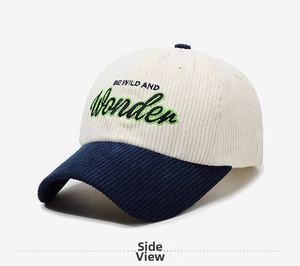 Detail of two-tone corduroy baseball cap featuring BE WILD AND Wonder embroidery