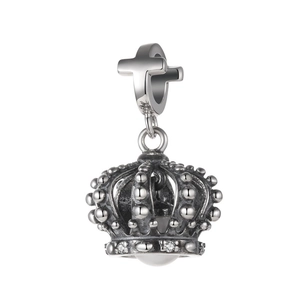 Macro shot of silver crown charm with bead texture, small diamonds and white pearl