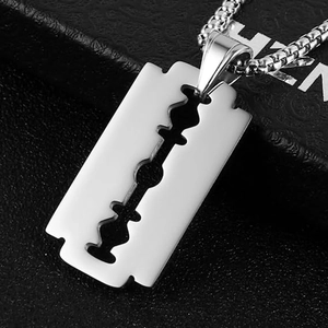 Macro shot of silver stainless steel razor blade pendant on thick metal chain
