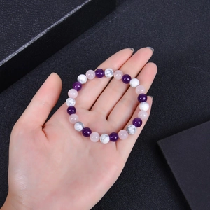 Beaded bracelet with amethyst, rose quartz, and white turquoise on a woman's wrist