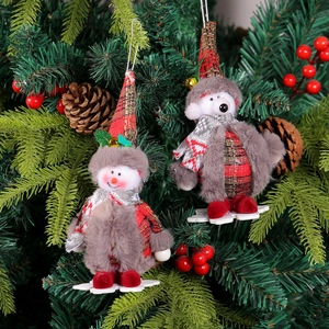 Festive Christmas gnome ornament with plaid hat and snowflake base on a tree