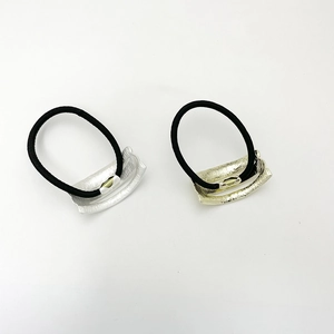 Minimalist elastic hair ties with gold and silver wave textured metal ornaments in black