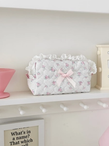 Detail of floral quilted cosmetic bag with pink roses, lace trim and silk ribbon bow